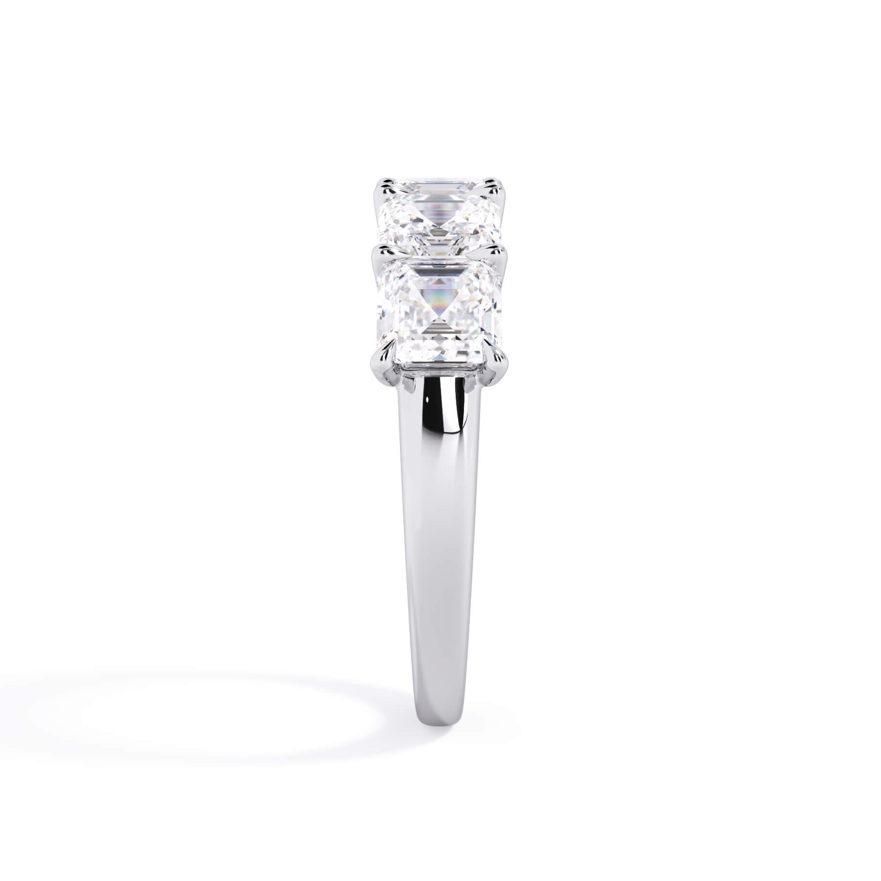 A picture of a five stone diamond wedding ring with asscher shape diamonds that are u prong set in white gold or platinum on a white background with a side profile view.