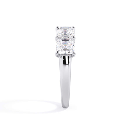 A picture of a five stone diamond wedding ring with asscher shape diamonds that are u prong set in white gold or platinum on a white background with a side profile view.