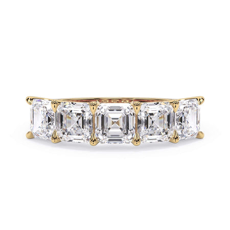 A picture of a five stone diamond wedding ring with asscher shape diamonds that are u prong set in yellow gold on a white background with the ring facing forward, lying down.