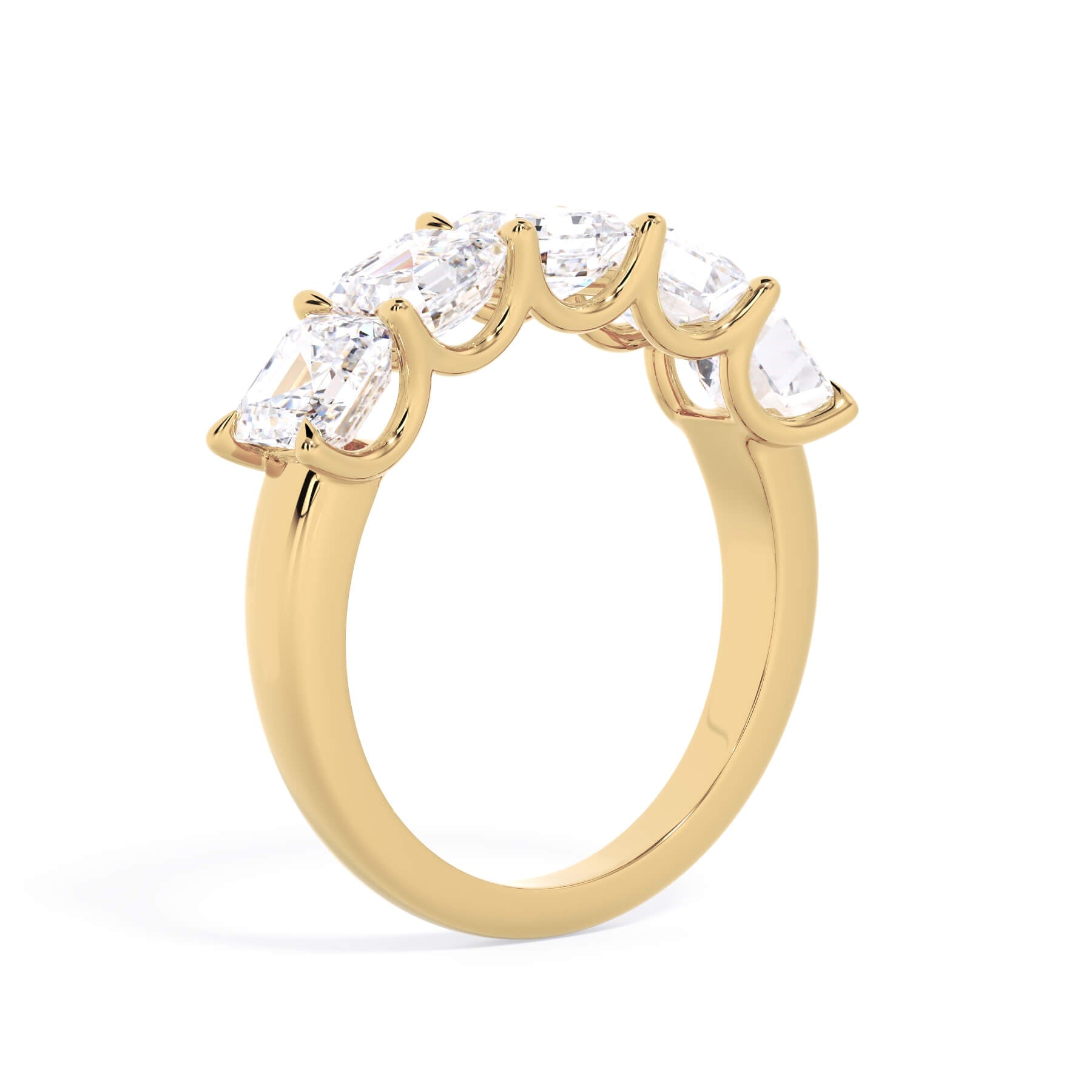 A picture of a five stone diamond wedding ring with asscher shape diamonds that are u prong set in yellow gold on a white background with a slightly angled, through the finger view.