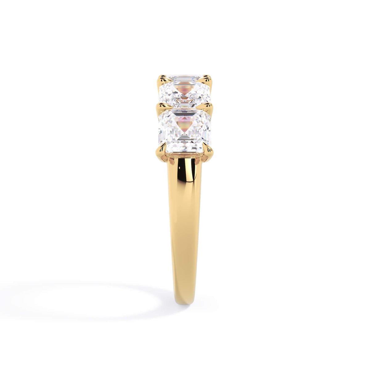 A picture of a five stone diamond wedding ring with asscher shape diamonds that are u prong set in yellow gold on a white background with a side profile view.