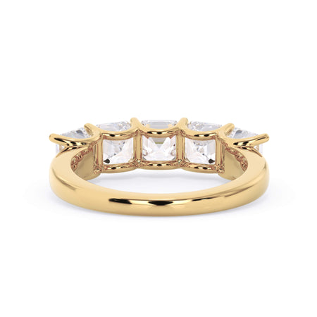 A picture of a five stone diamond wedding ring with asscher shape diamonds that are u prong set in yellow gold on a white background with a view of the underside of the ring.