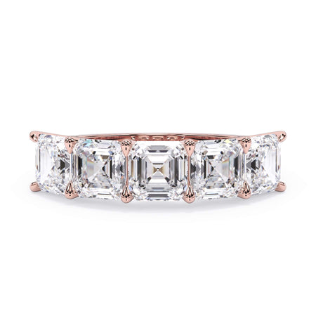 A picture of a five stone diamond wedding ring with asscher shape diamonds that are u prong set in rose gold on a white background with the ring facing forward, lying down.