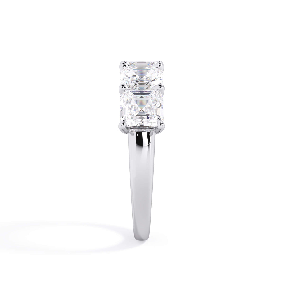 A picture of a five stone diamond wedding ring with asscher shape diamonds that are u prong set in white gold or platinum on a white background with a side profile view.