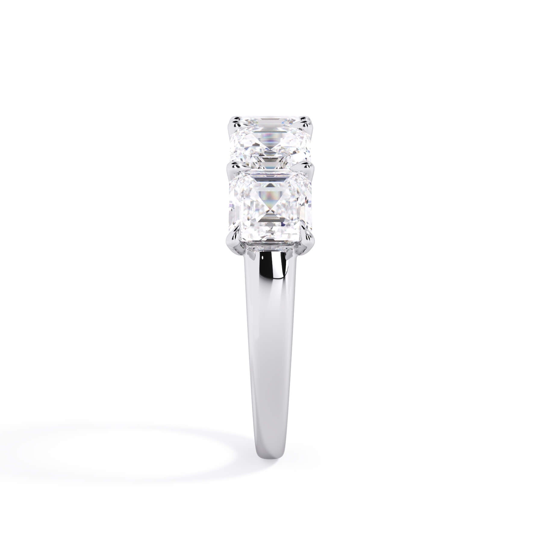 A picture of a five stone diamond wedding ring with asscher shape diamonds that are u prong set in white gold or platinum on a white background with a side profile view.