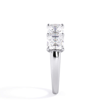 A picture of a five stone diamond wedding ring with asscher shape diamonds that are u prong set in white gold or platinum on a white background with a side profile view.