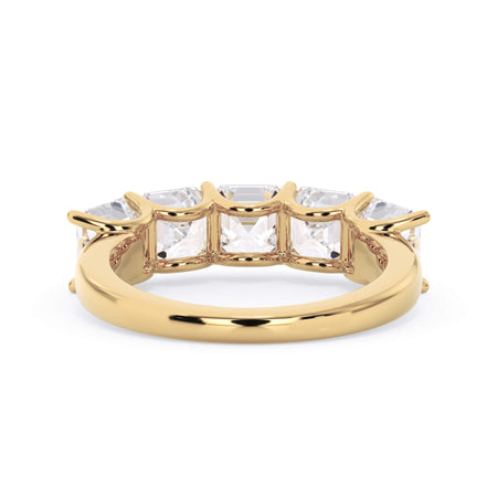 A picture of a five stone diamond wedding ring with asscher shape diamonds that are u prong set in yellow gold on a white background with a view of the underside of the ring.