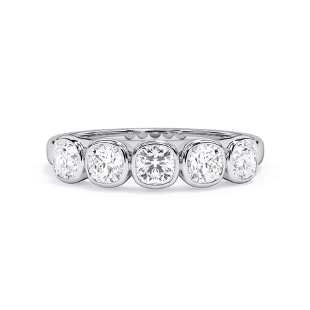 A picture of a five stone diamond wedding ring with cushion shape diamonds that are bezel set in white gold or platinum on a white background with the ring facing forward, lying down.