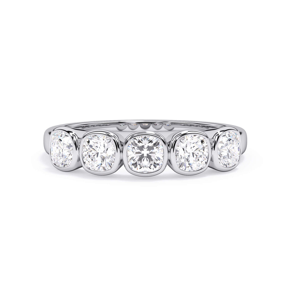 A picture of a five stone diamond wedding ring with cushion shape diamonds that are bezel set in white gold or platinum on a white background with the ring facing forward, lying down.