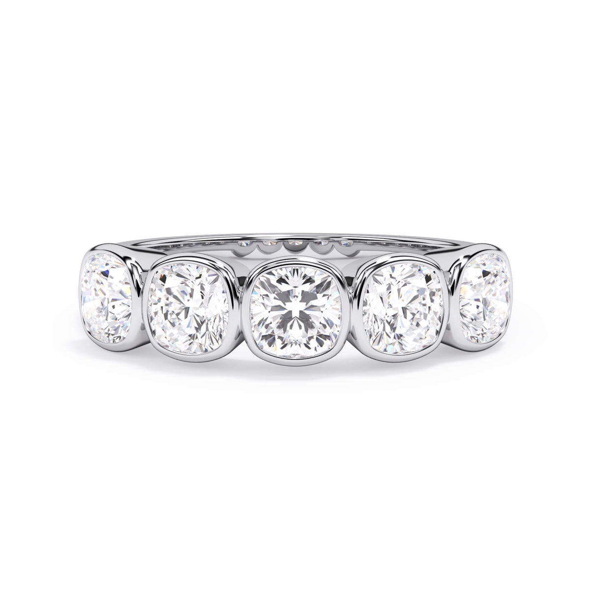 A picture of a five stone diamond wedding ring with cushion shape diamonds that are bezel set in white gold or platinum on a white background with the ring facing forward, lying down.
