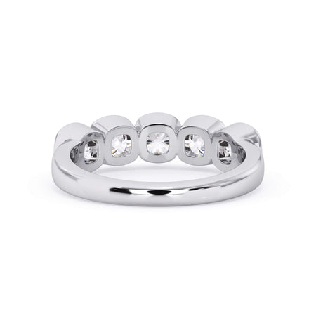 A picture of a five stone diamond wedding ring with cushion shape diamonds that are bezel set in white gold or platinum on a white background with a view of the underside of the ring.