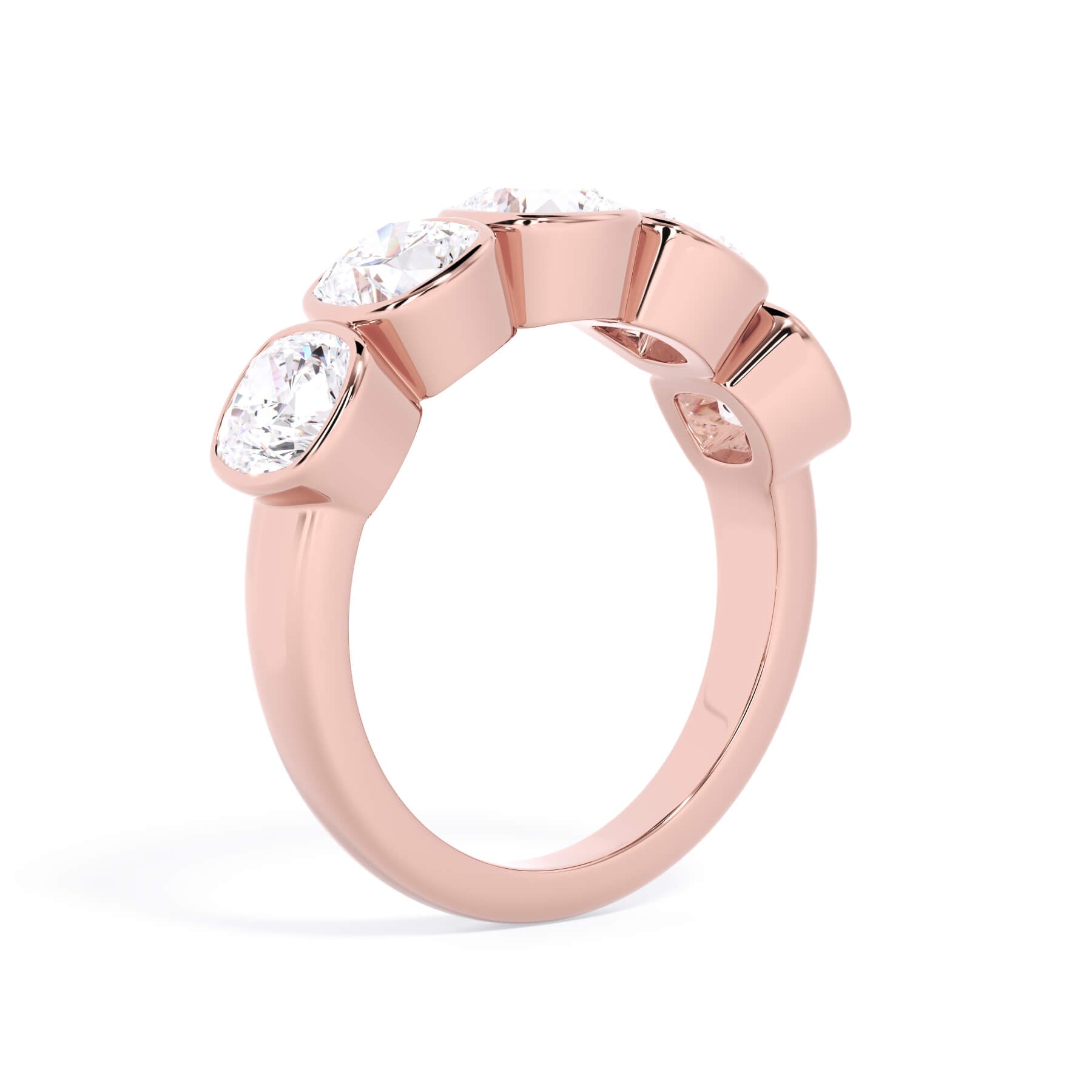A picture of a five stone diamond wedding ring with cushion shape diamonds that are bezel set in rose gold on a white background with a slightly angled, through the finger view.