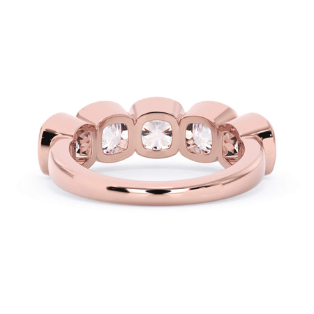 A picture of a five stone diamond wedding ring with cushion shape diamonds that are bezel set in rose gold on a white background with a view of the underside of the ring.