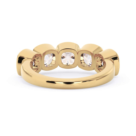 A picture of a five stone diamond wedding ring with cushion shape diamonds that are bezel set in yellow gold on a white background with a view of the underside of the ring.