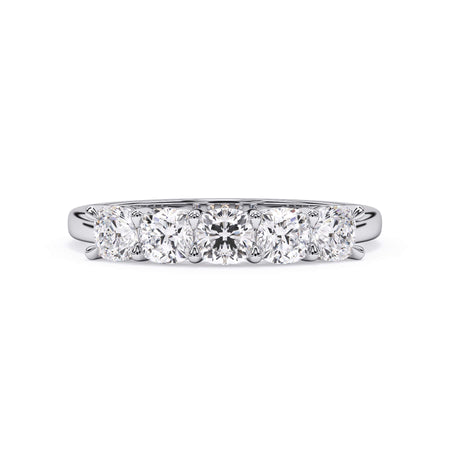 A picture of a five stone diamond wedding ring with cushion shape diamonds that are shared prong set in white gold or platinum on a white background with the ring facing forward, lying down.