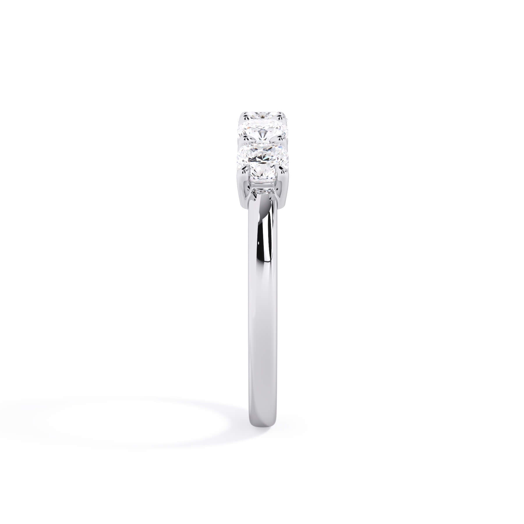 A picture of a five stone diamond wedding ring with cushion shape diamonds that are shared prong set in white gold or platinum on a white background with a side profile view.