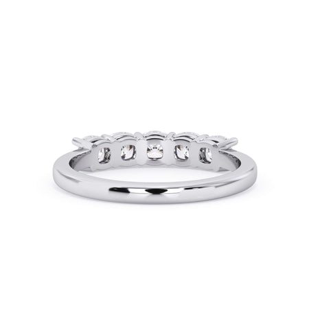 A picture of a five stone diamond wedding ring with cushion shape diamonds that are shared prong set in white gold or platinum on a white background with a view of the underside of the ring.