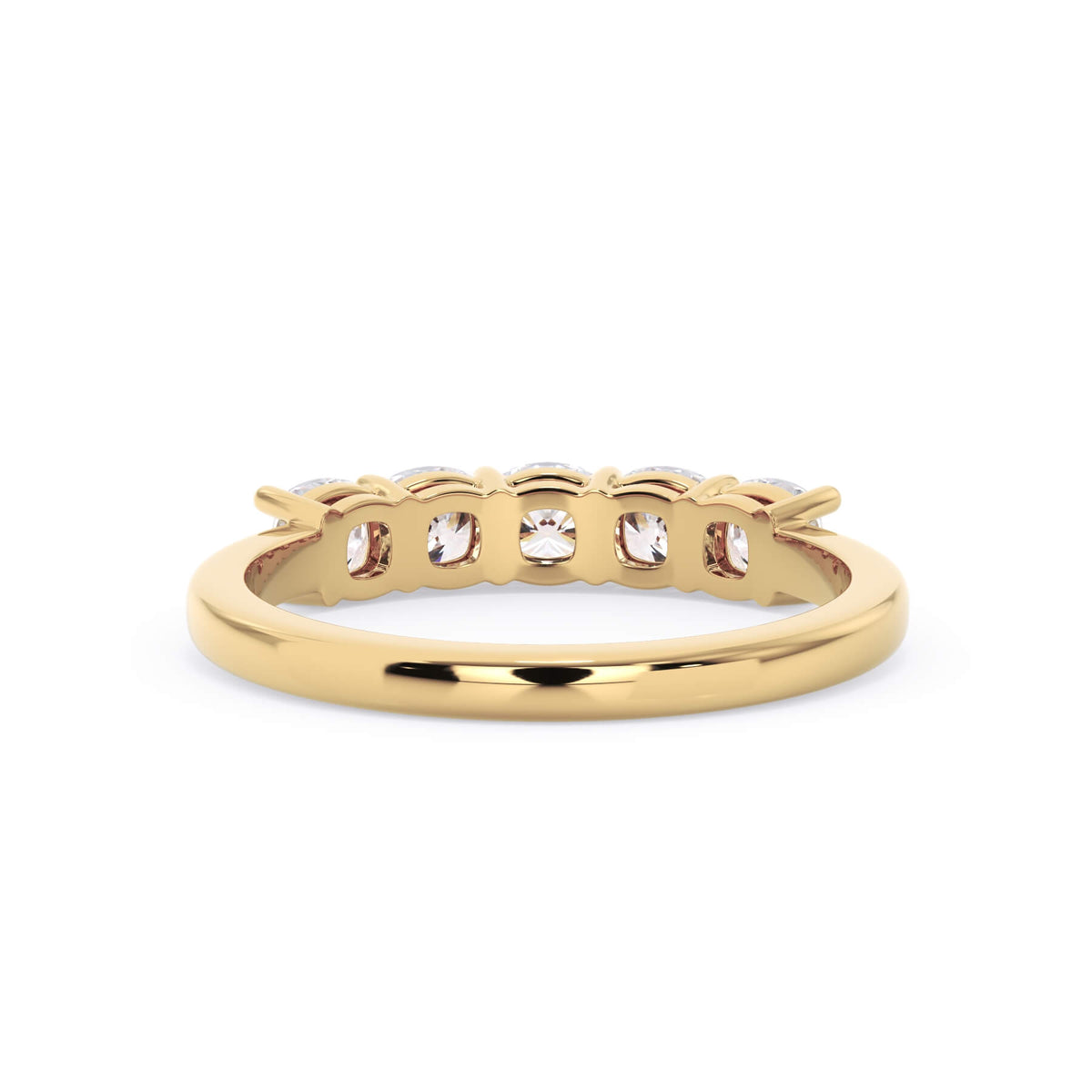 A picture of a five stone diamond wedding ring with cushion shape diamonds that are shared prong set in yellow gold on a white background with a view of the underside of the ring.