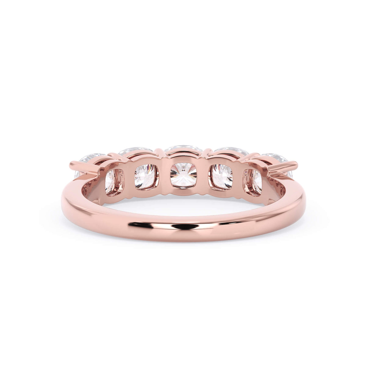 A picture of a five stone diamond wedding ring with cushion shape diamonds that are shared prong set in rose gold on a white background with a view of the underside of the ring.