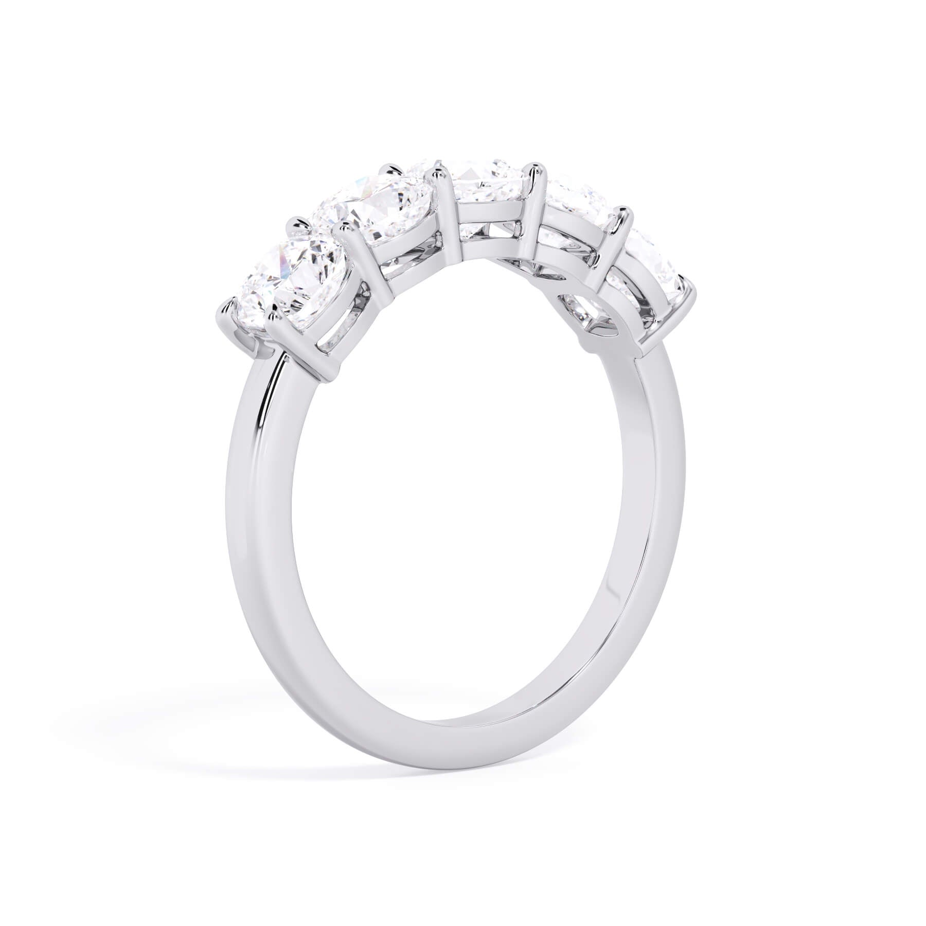 A picture of a five stone diamond wedding ring with cushion shape diamonds that are shared prong set in white gold or platinum on a white background with a slightly angled, through the finger view.
