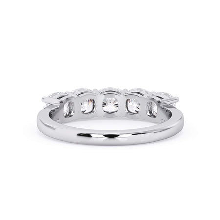 A picture of a five stone diamond wedding ring with cushion shape diamonds that are shared prong set in white gold or platinum on a white background with a view of the underside of the ring.