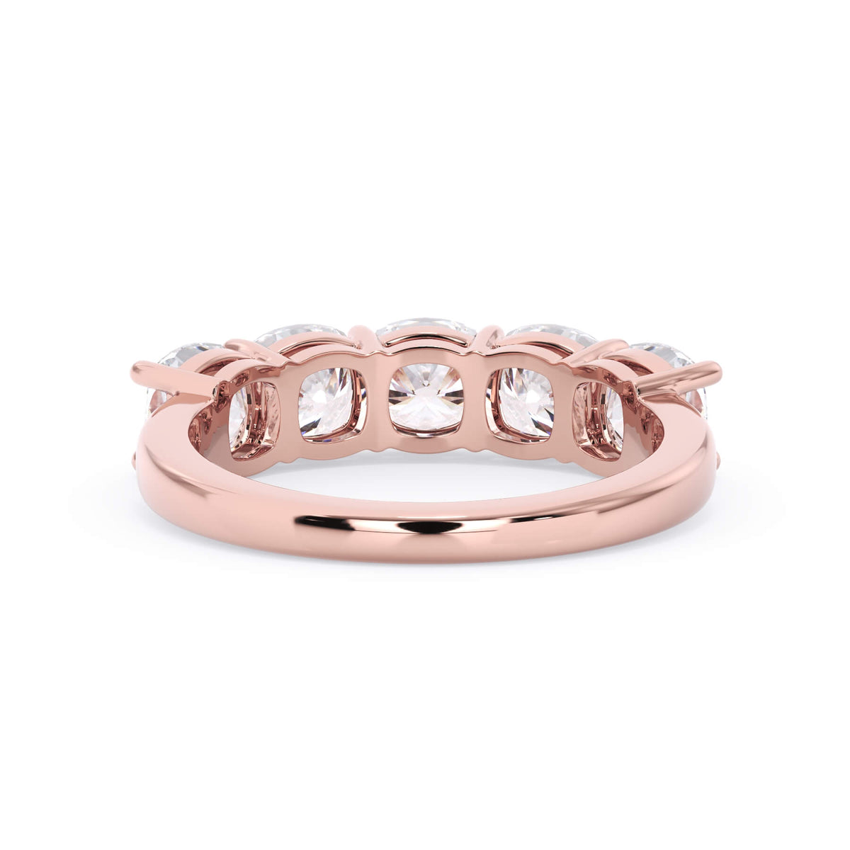 A picture of a five stone diamond wedding ring with cushion shape diamonds that are shared prong set in rose gold on a white background with a view of the underside of the ring.