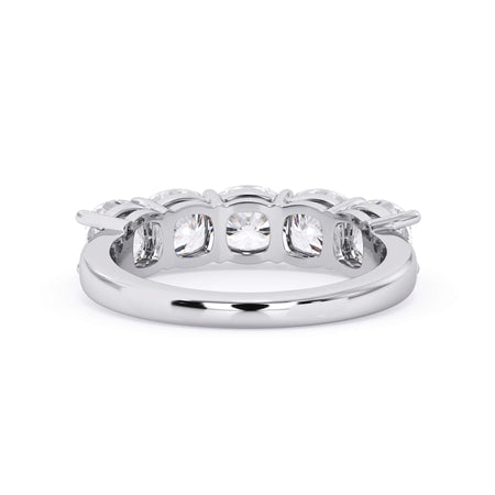 A picture of a five stone diamond wedding ring with cushion shape diamonds that are shared prong set in white gold or platinum on a white background with a view of the underside of the ring.
