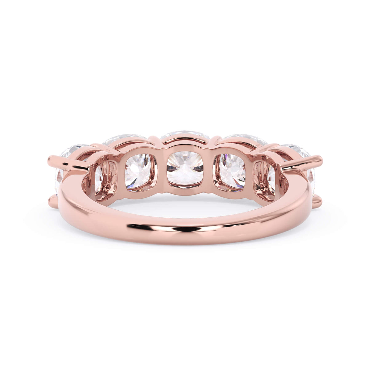 A picture of a five stone diamond wedding ring with cushion shape diamonds that are shared prong set in rose gold on a white background with a view of the underside of the ring.
