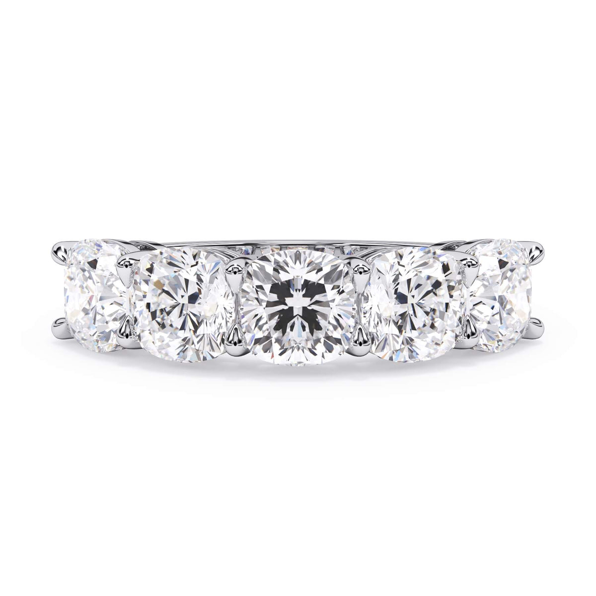A picture of a five stone diamond wedding ring with cushion shape diamonds that are shared prong set in white gold or platinum on a white background with the ring facing forward, lying down.