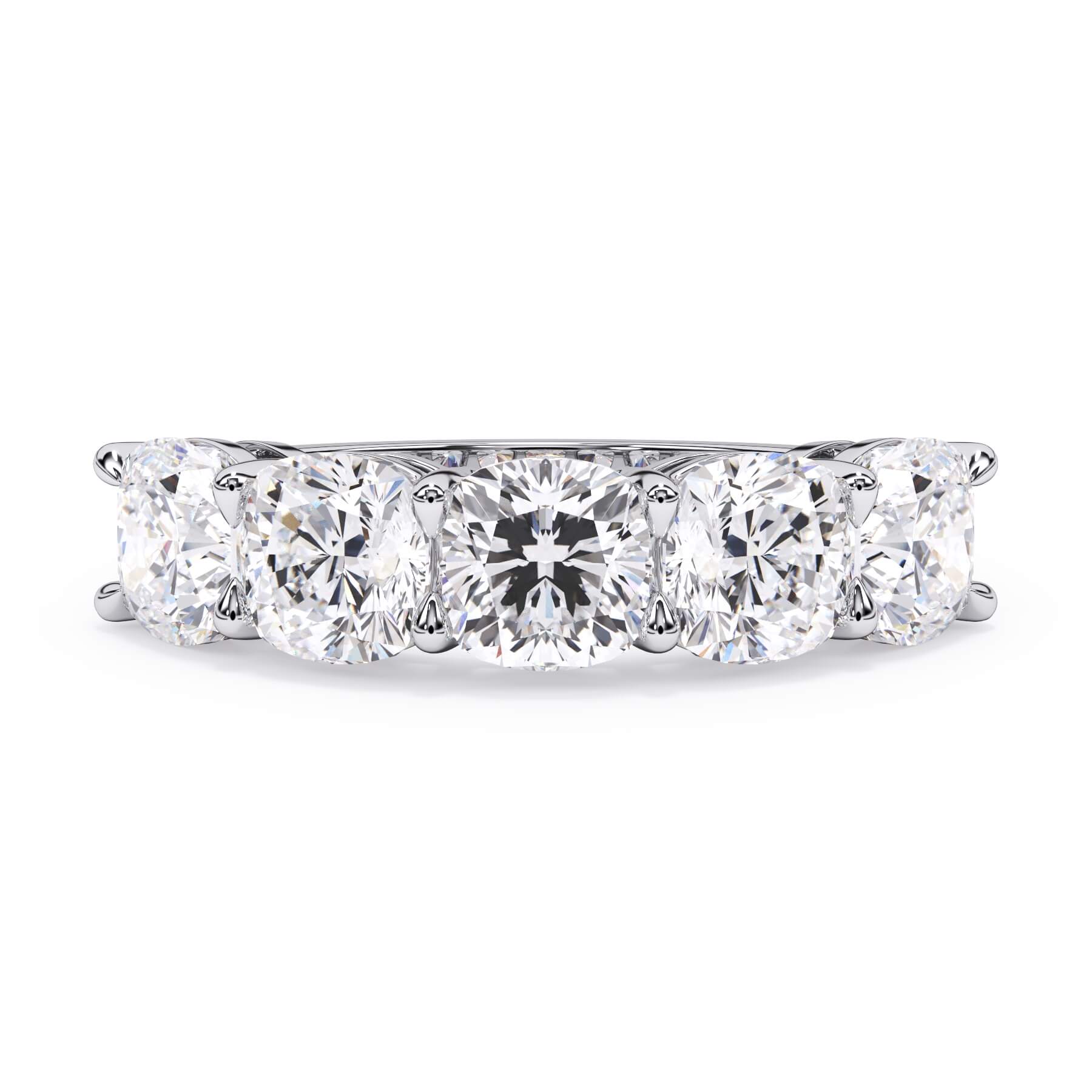 A picture of a five stone diamond wedding ring with cushion shape diamonds that are shared prong set in white gold or platinum on a white background with the ring facing forward, lying down.