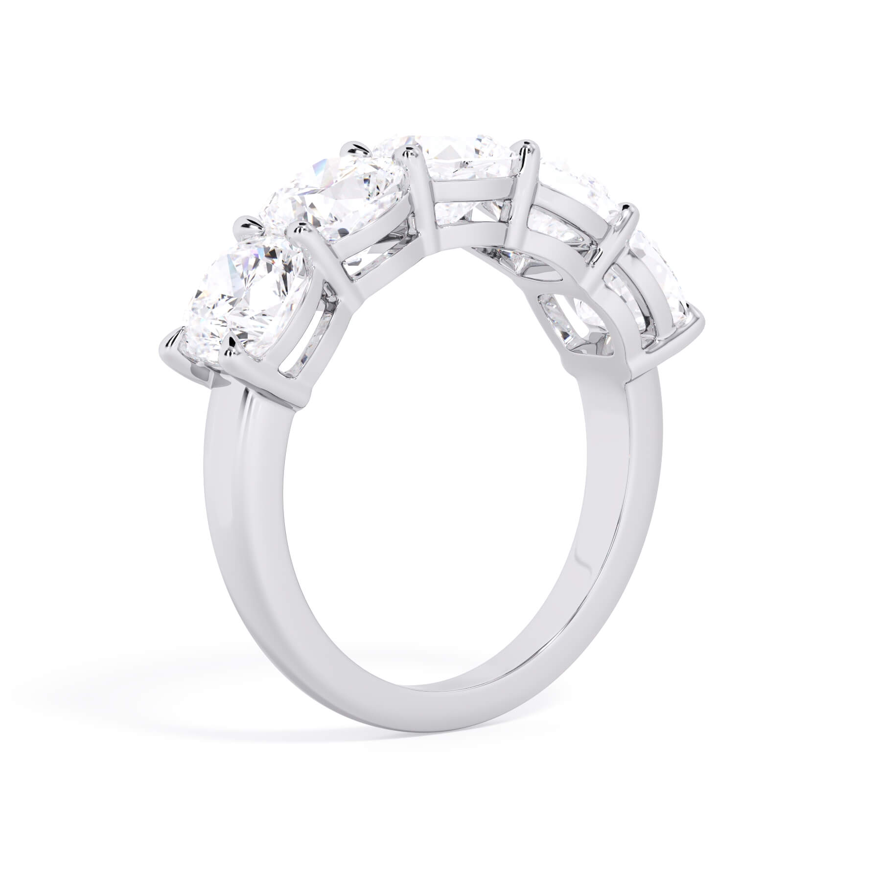 A picture of a five stone diamond wedding ring with cushion shape diamonds that are shared prong set in white gold or platinum on a white background with a slightly angled, through the finger view.