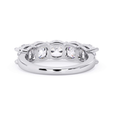 A picture of a five stone diamond wedding ring with cushion shape diamonds that are shared prong set in white gold or platinum on a white background with a view of the underside of the ring.