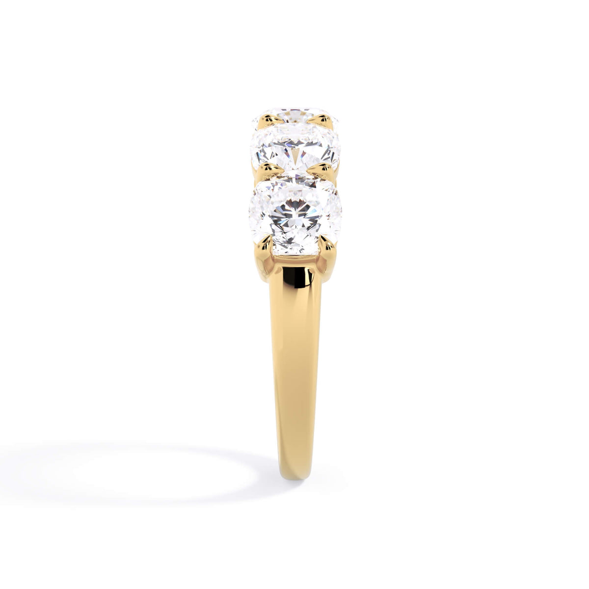 A picture of a five stone diamond wedding ring with cushion shape diamonds that are shared prong set in yellow gold on a white background with a side profile view.