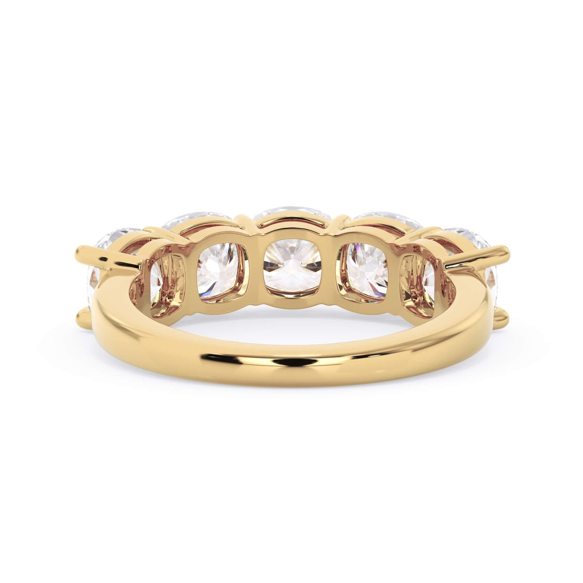 A picture of a five stone diamond wedding ring with cushion shape diamonds that are shared prong set in yellow gold on a white background with a view of the underside of the ring.