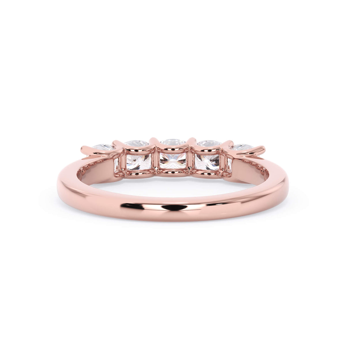 A picture of a five stone diamond wedding ring with cushion shape diamonds that are u prong set in rose gold on a white background with a view of the underside of the ring.