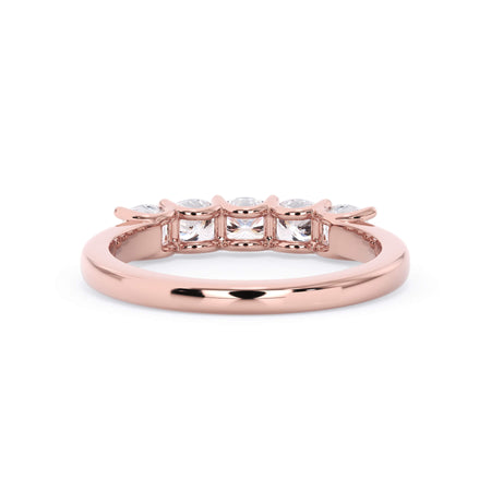 A picture of a five stone diamond wedding ring with cushion shape diamonds that are u prong set in rose gold on a white background with a view of the underside of the ring.