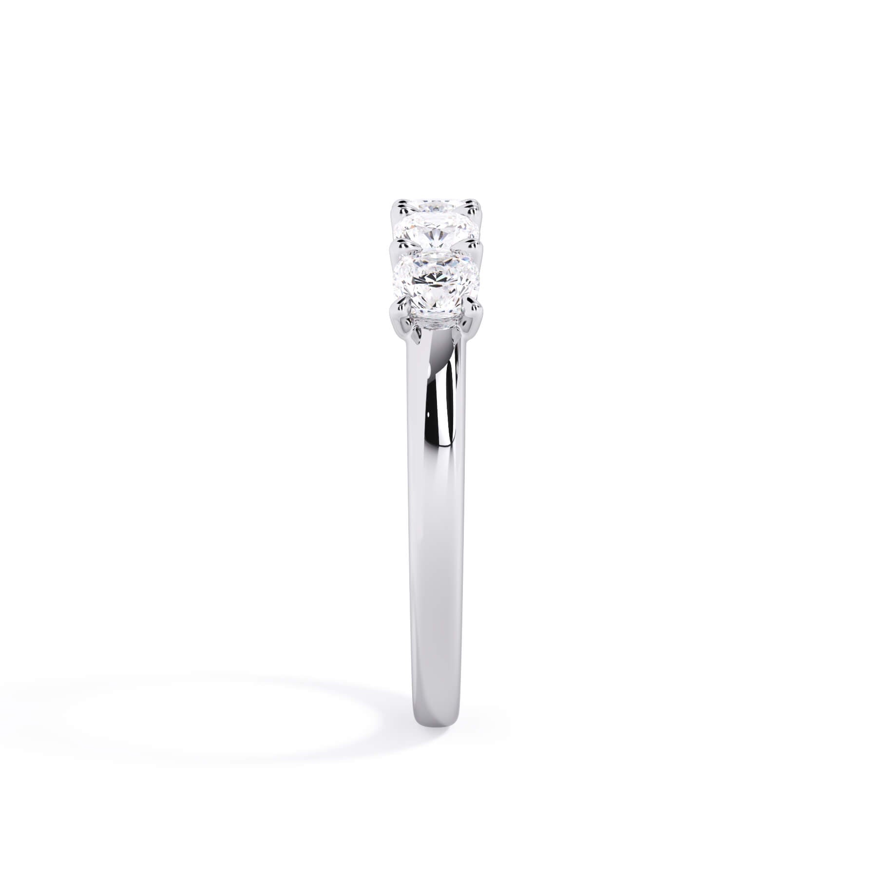A picture of a five stone diamond wedding ring with cushion shape diamonds that are u prong set in white gold or platinum on a white background with a side profile view.