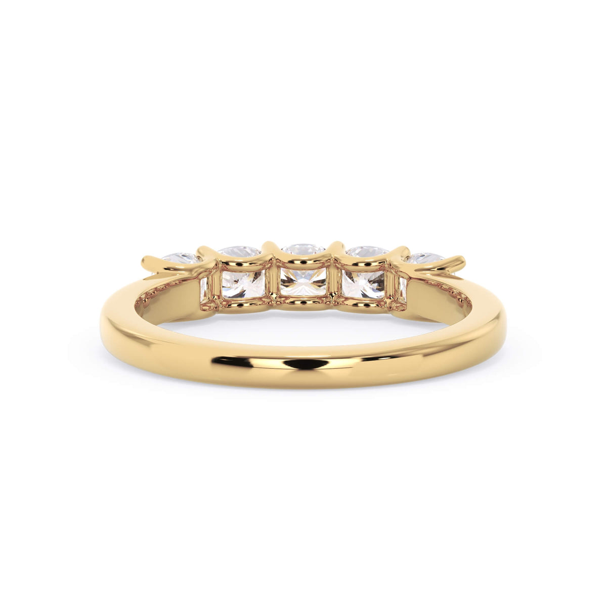 A picture of a five stone diamond wedding ring with cushion shape diamonds that are u prong set in yellow gold on a white background with a view of the underside of the ring.
