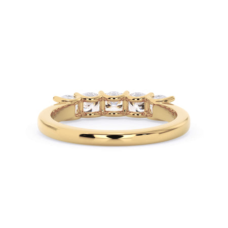 A picture of a five stone diamond wedding ring with cushion shape diamonds that are u prong set in yellow gold on a white background with a view of the underside of the ring.