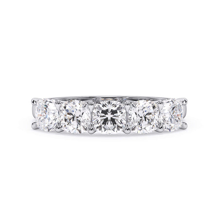 A picture of a five stone diamond wedding ring with cushion shape diamonds that are u prong set in white gold or platinum on a white background with the ring facing forward, lying down.