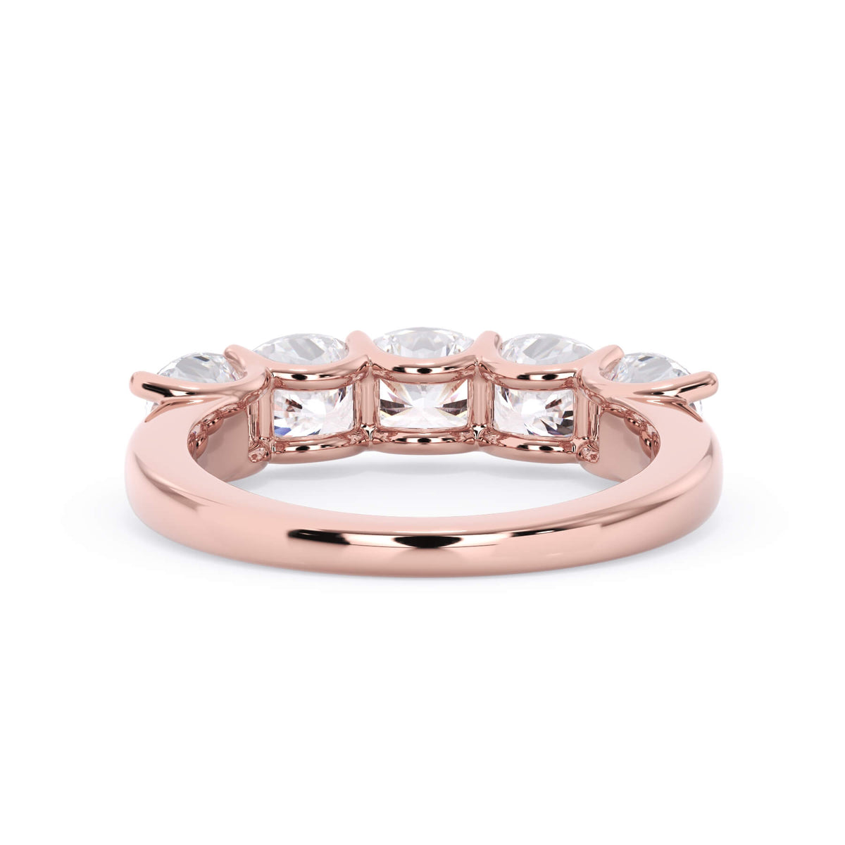 A picture of a five stone diamond wedding ring with cushion shape diamonds that are u prong set in rose gold on a white background with a view of the underside of the ring.