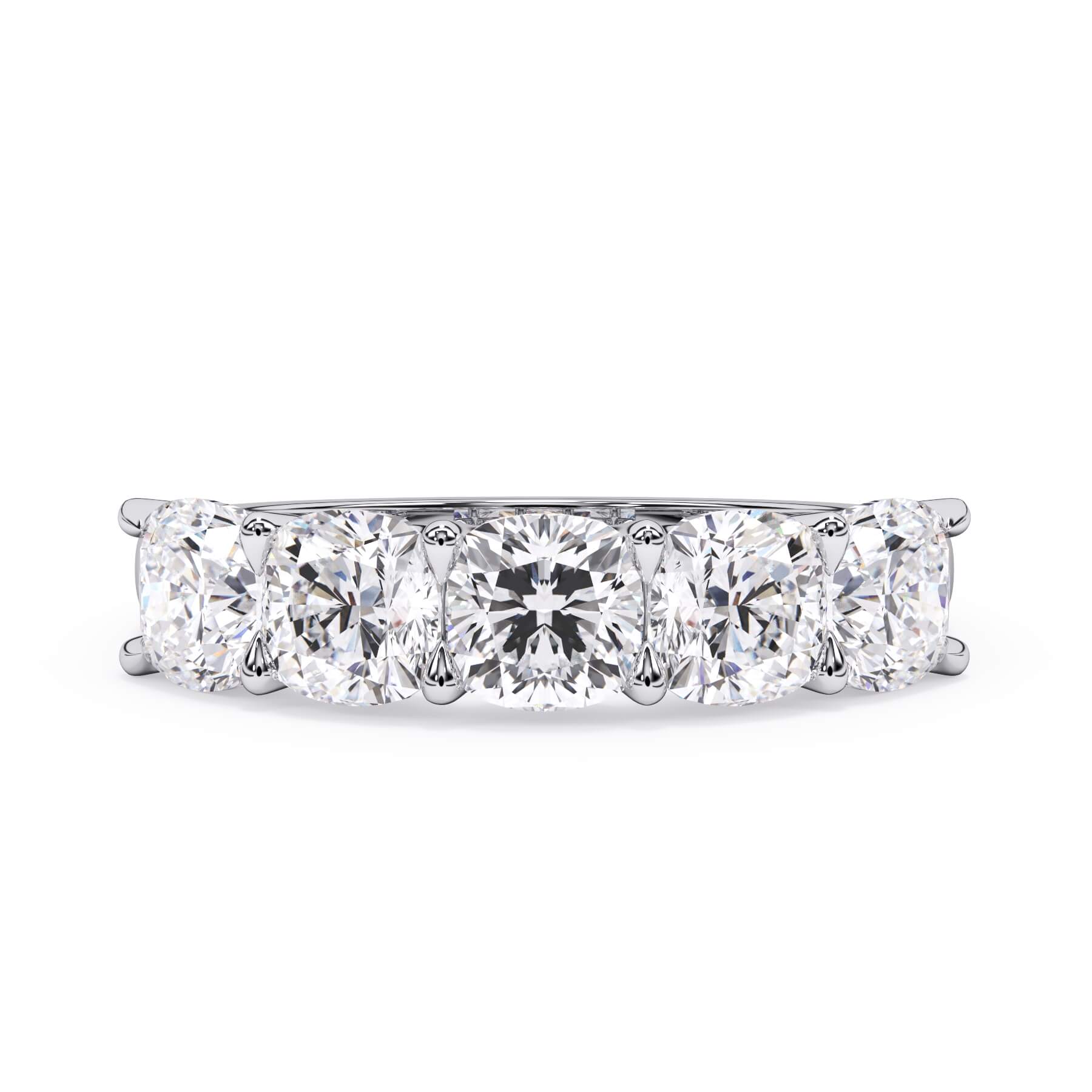 A picture of a five stone diamond wedding ring with cushion shape diamonds that are u prong set in white gold or platinum on a white background with the ring facing forward, lying down.