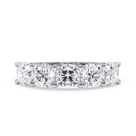 A picture of a five stone diamond wedding ring with cushion shape diamonds that are u prong set in white gold or platinum on a white background with the ring facing forward, lying down.