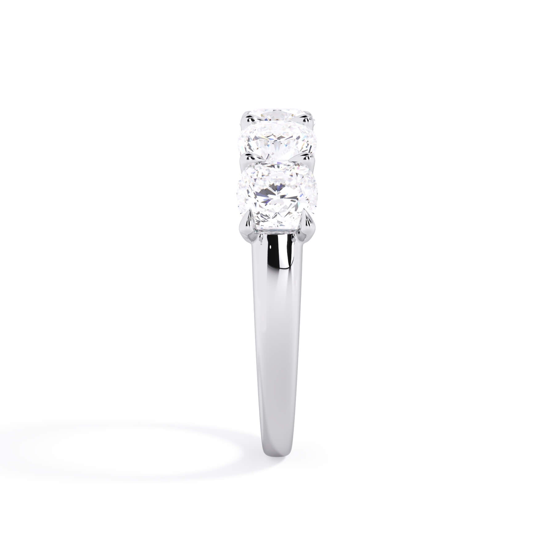 A picture of a five stone diamond wedding ring with cushion shape diamonds that are u prong set in white gold or platinum on a white background with a side profile view.