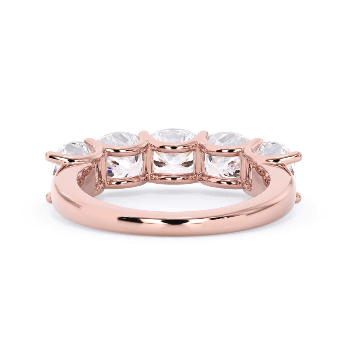 A picture of a five stone diamond wedding ring with cushion shape diamonds that are u prong set in rose gold on a white background with a view of the underside of the ring.
