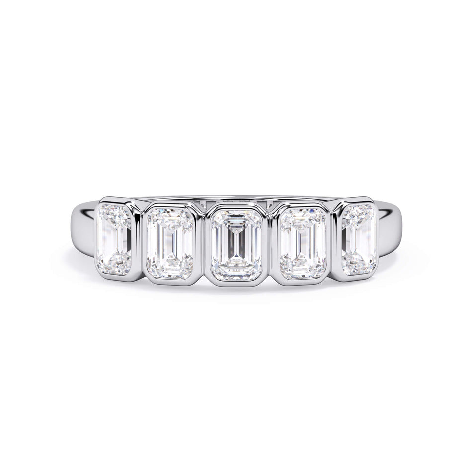 A picture of a five stone diamond wedding ring with emerald cut diamonds that are bezel set in white gold or platinum on a white background with the ring facing forward, lying down.