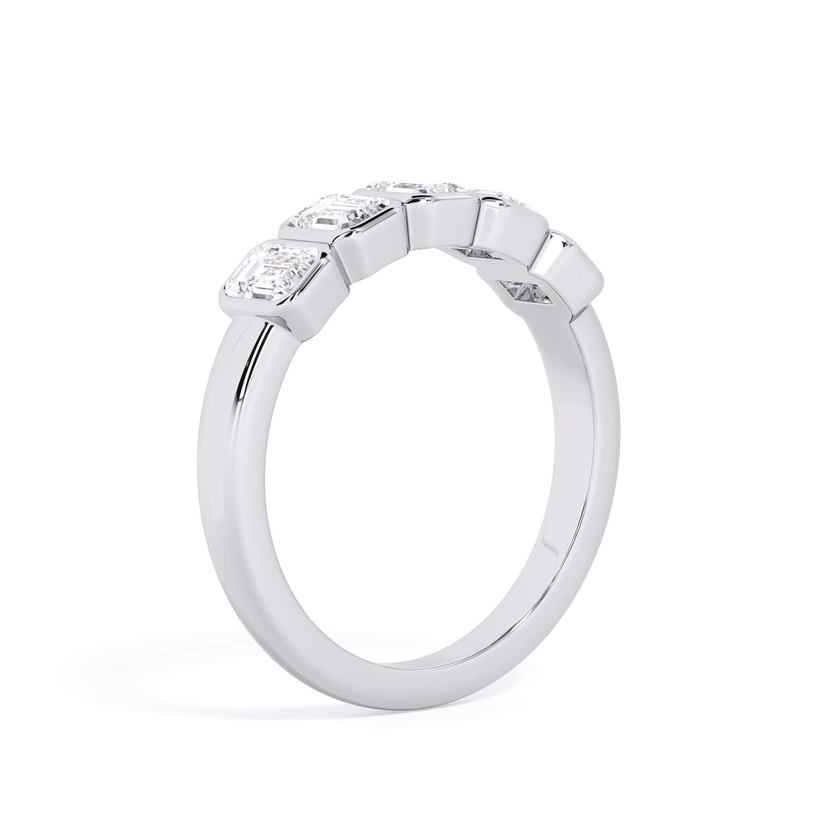 A picture of a five stone diamond wedding ring with emerald cut diamonds that are bezel set in white gold or platinum on a white background with a slightly angled, through the finger view.
