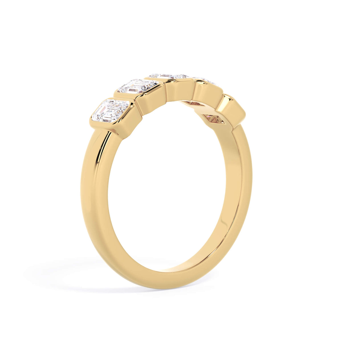 A picture of a five stone diamond wedding ring with emerald cut diamonds that are bezel set in yellow gold on a white background with a slightly angled, through the finger view.