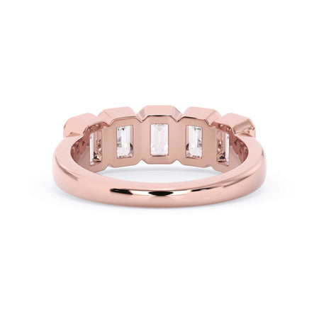 A picture of a five stone diamond wedding ring with emerald cut diamonds that are bezel set in rose gold on a white background with a view of the underside of the ring.