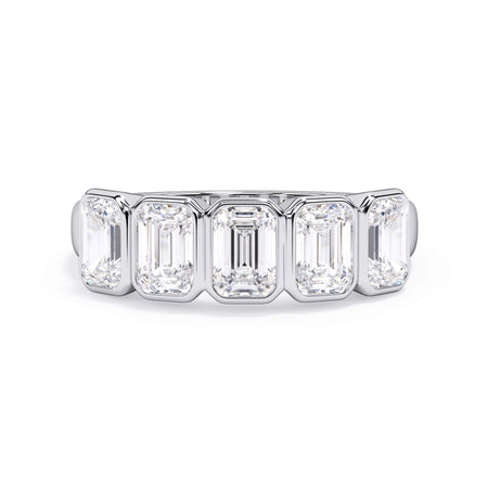 A picture of a five stone diamond wedding ring with emerald cut diamonds that are bezel set in white gold or platinum on a white background with the ring facing forward, lying down.